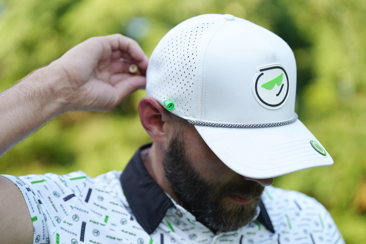 Man wearing white Onesome golf hat